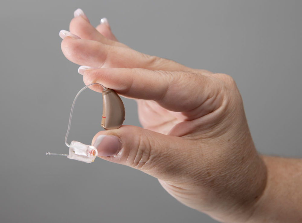 Jennifer Nealon, Marketing Director at Hear Again America, holds a hearing aid that they sell on October 19, 2021 in Boca Raton, Florida. hearing. (Joe Raedle/Getty Images)