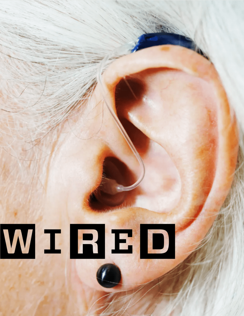 Photo of the ear of an elderly white woman wearing a hearing aid 